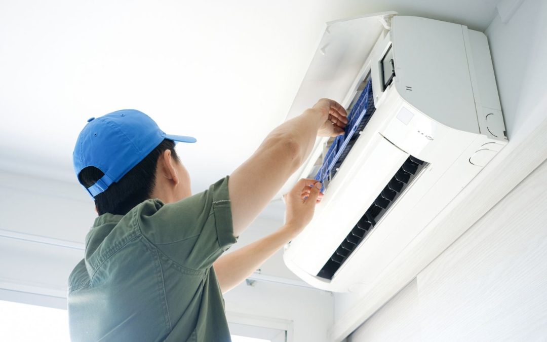 Air conditioning technician maintaining an indoor mini split system in Casa Grande, AZ