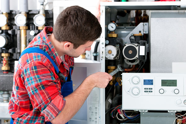 HVAC technician inspecting an indoor heating system in Casa Grande, AZ