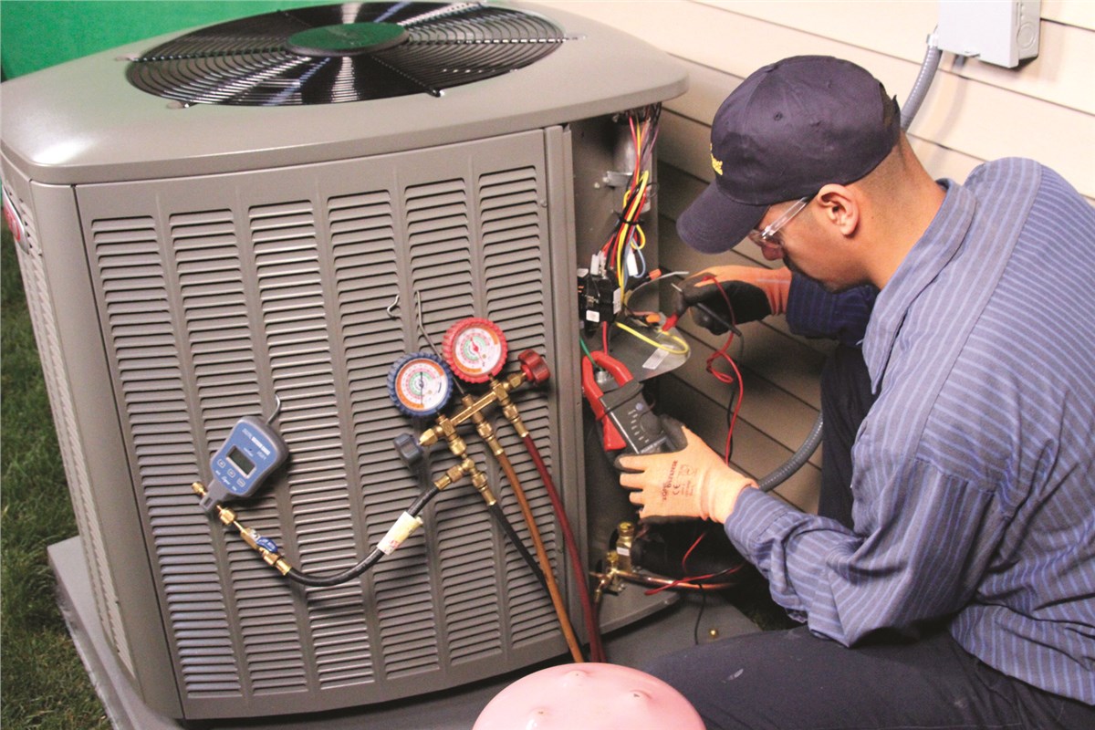 HVAC technician testing an outdoor air conditioning unit in Casa Grande