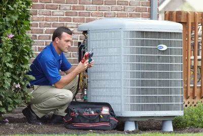 HVAC technician inspecting an outdoor air conditioning unit in Casa Grande, AZ